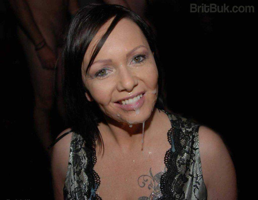 British MILF posing smiling wearing a CUM MASK